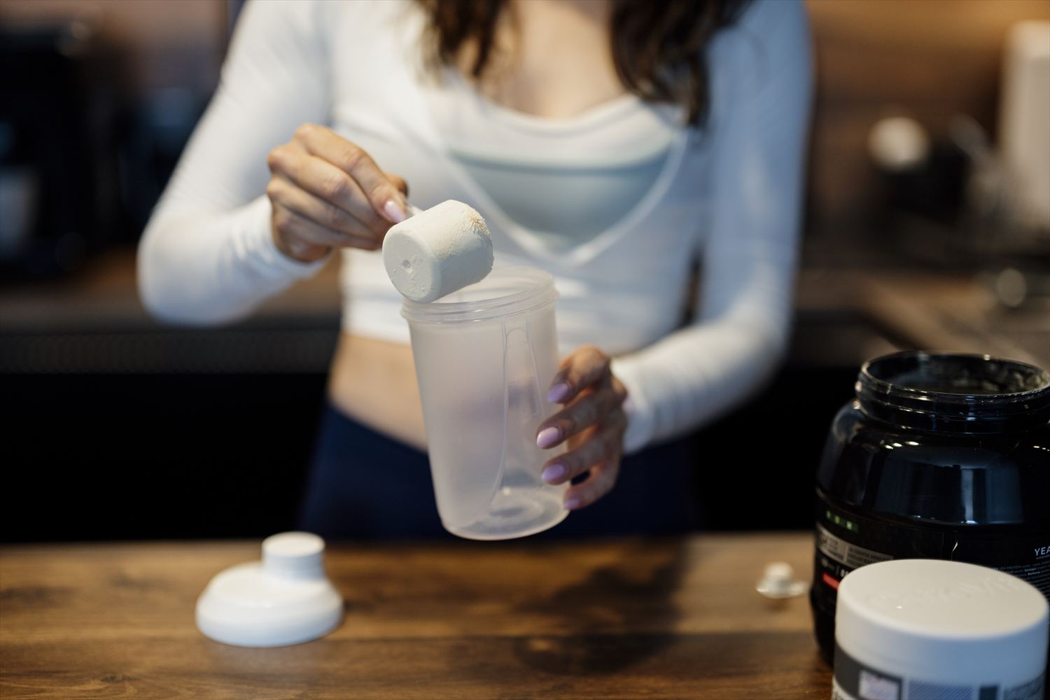 Placeholder image — protein tub, scoop and a printed supplement label